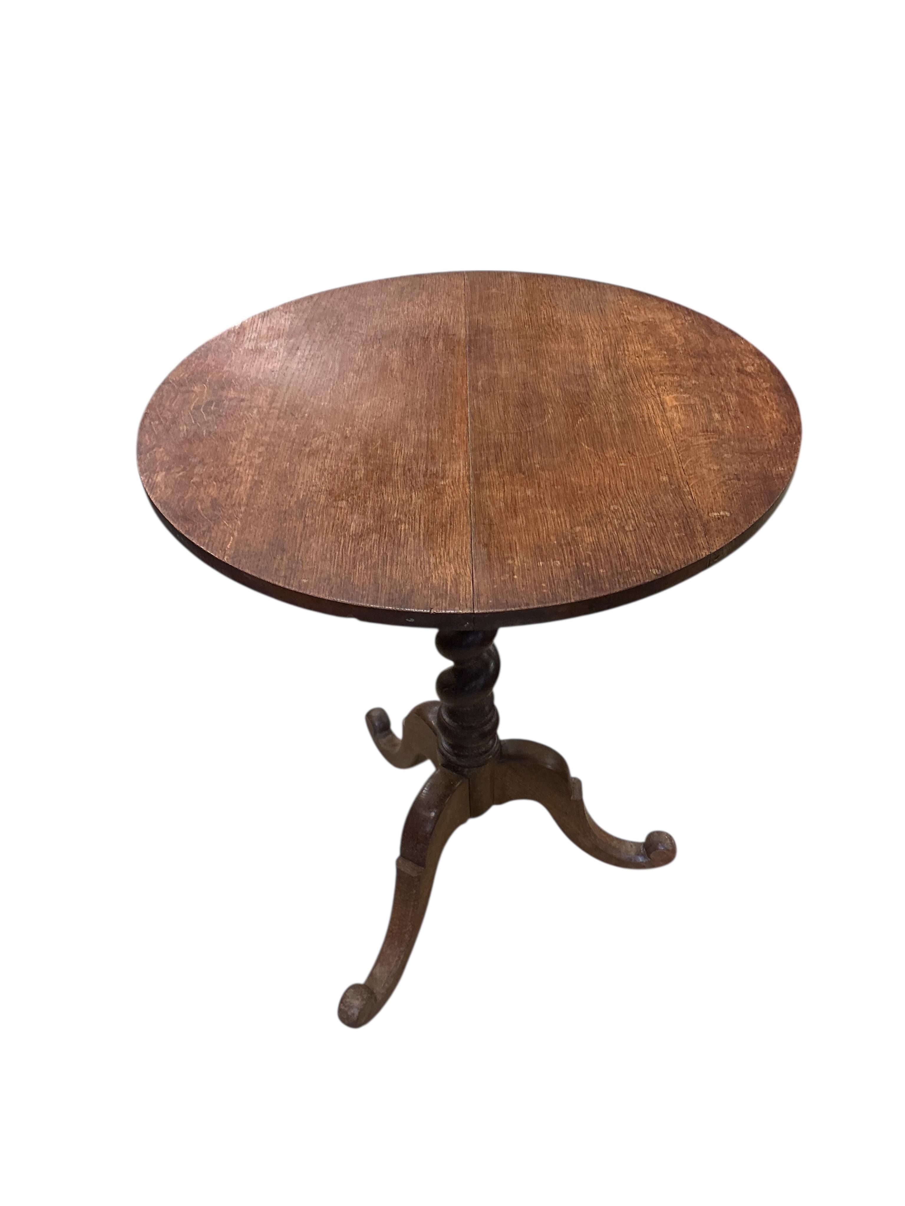 A 19th century circular oak tilt top tripod wine table, diameter 60cm, height 72cm